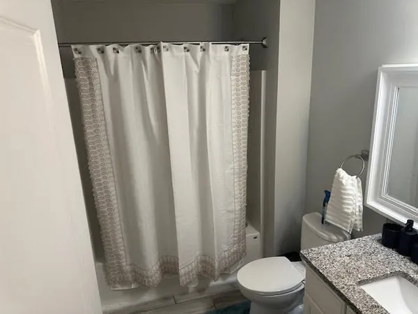 a bedroom with a bed and a view of bathroom