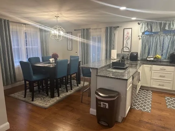 a kitchen with stainless steel appliances a stove a sink dishwasher a refrigerator and a microwave