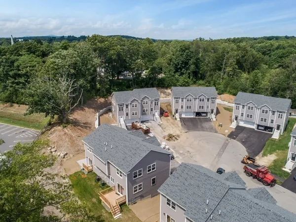 an aerial view of a house with a yard and lake view