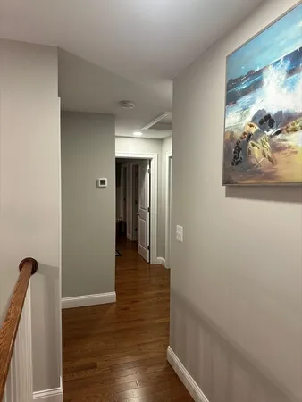 a large bed sitting in a bedroom next to a window