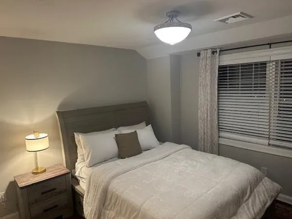 a bathroom with a granite countertop sink a mirror and toilet