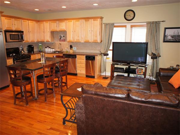 a view of a dining room with furniture and a flat screen tv