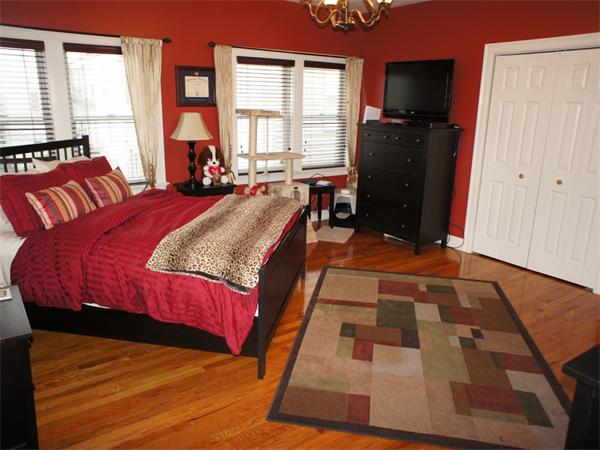 202 K Street, Unit 7 Boston, MA 02127 - Photo 8 of 10 a bed sitting in a bedroom next to a window with pc on the dresser