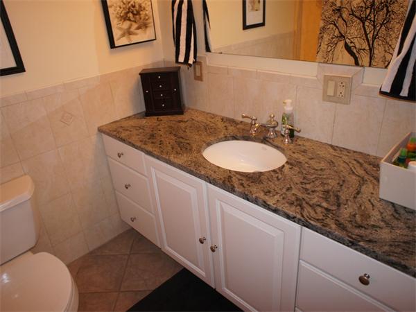202 K Street, Unit 7 Boston, MA 02127 - Photo 9 of 10 a bathroom with a granite countertop sink and a mirror