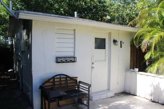 a view of a door and chair in the patio