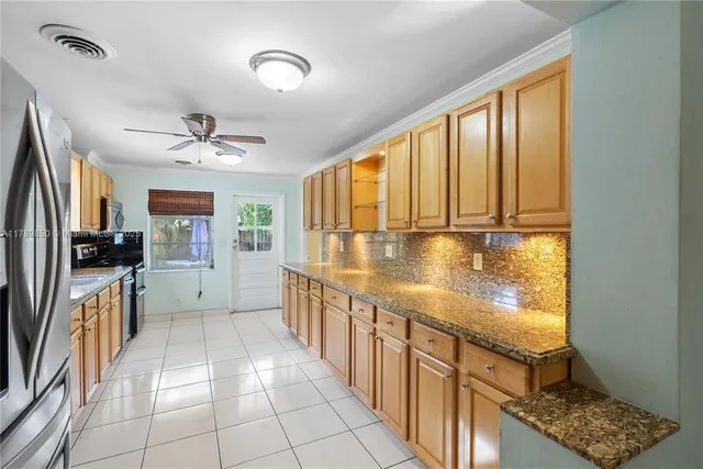 a view of a kitchen with a sink and dishwasher with wooden floor