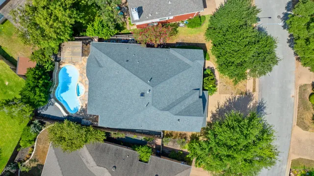 an aerial view of a house with a yard