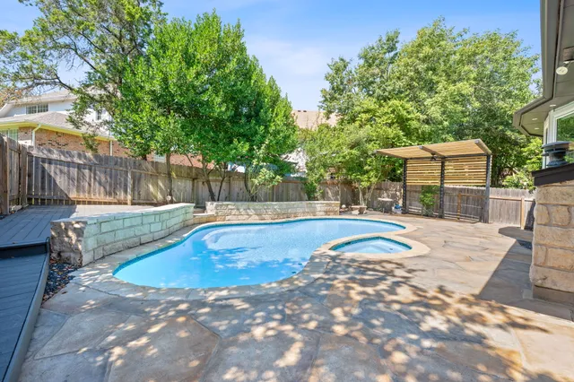 a bathroom with a sink double vanity granite tub shower and a mirror