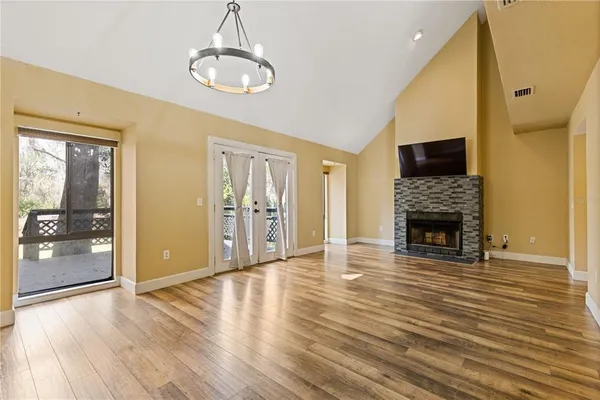 a view of a livingroom with wooden floor and a fireplace