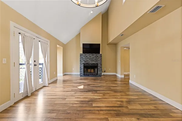a living room with wooden floors and a fireplace
