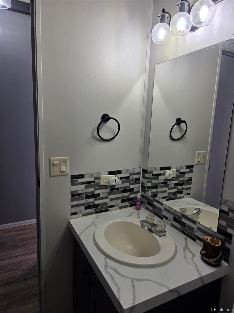 7881 Foothill Boulevard Alamosa, CO 81101 - Photo 11 of 25 a bathroom with a sink and a mirror