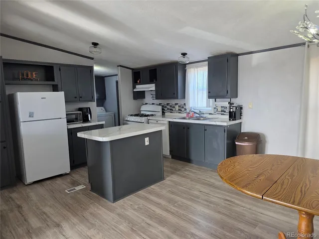 a kitchen with a sink appliances and cabinets