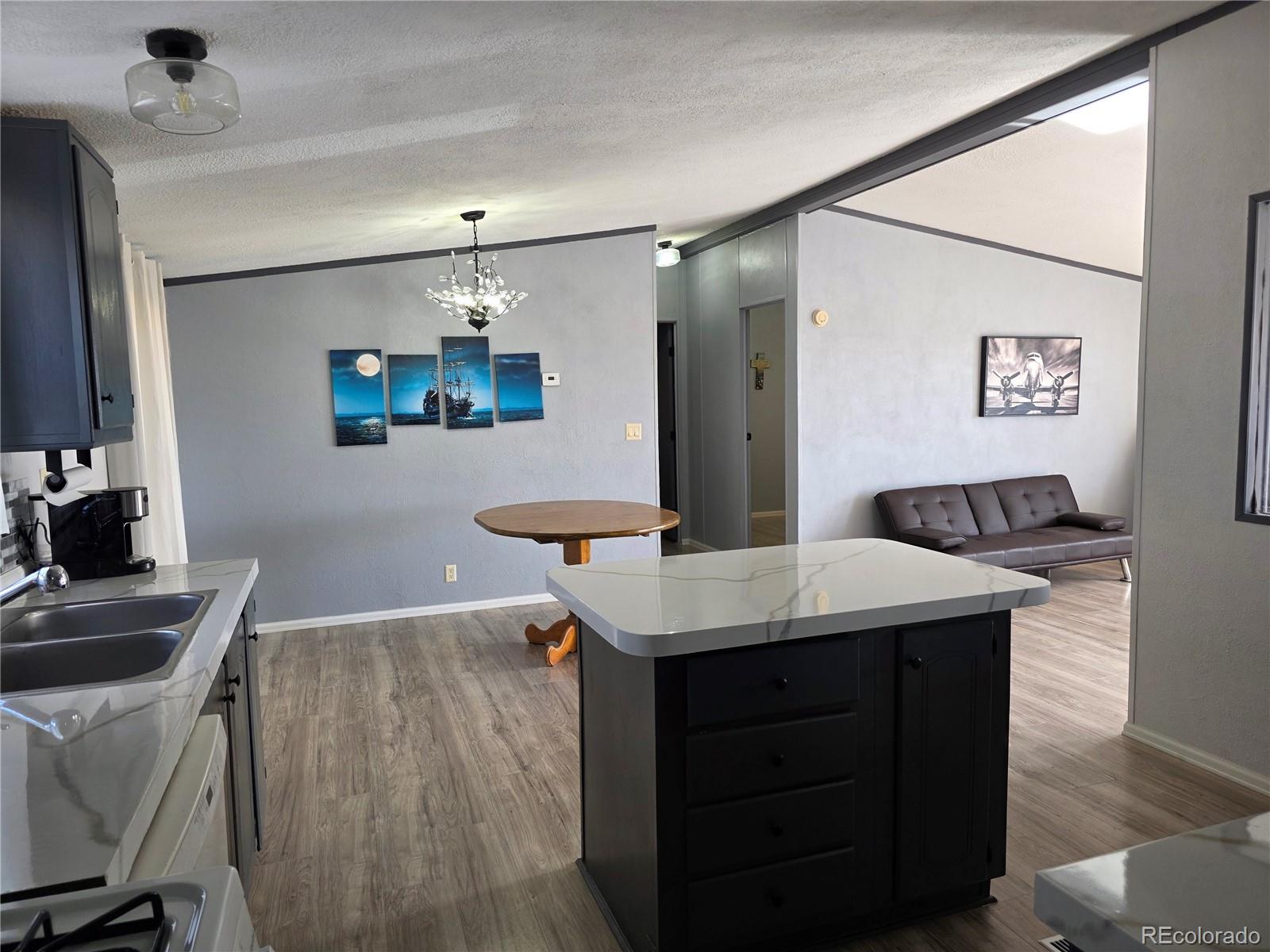 7881 Foothill Boulevard Alamosa, CO 81101 - Photo 6 of 25 a room with a table chairs and a refrigerator