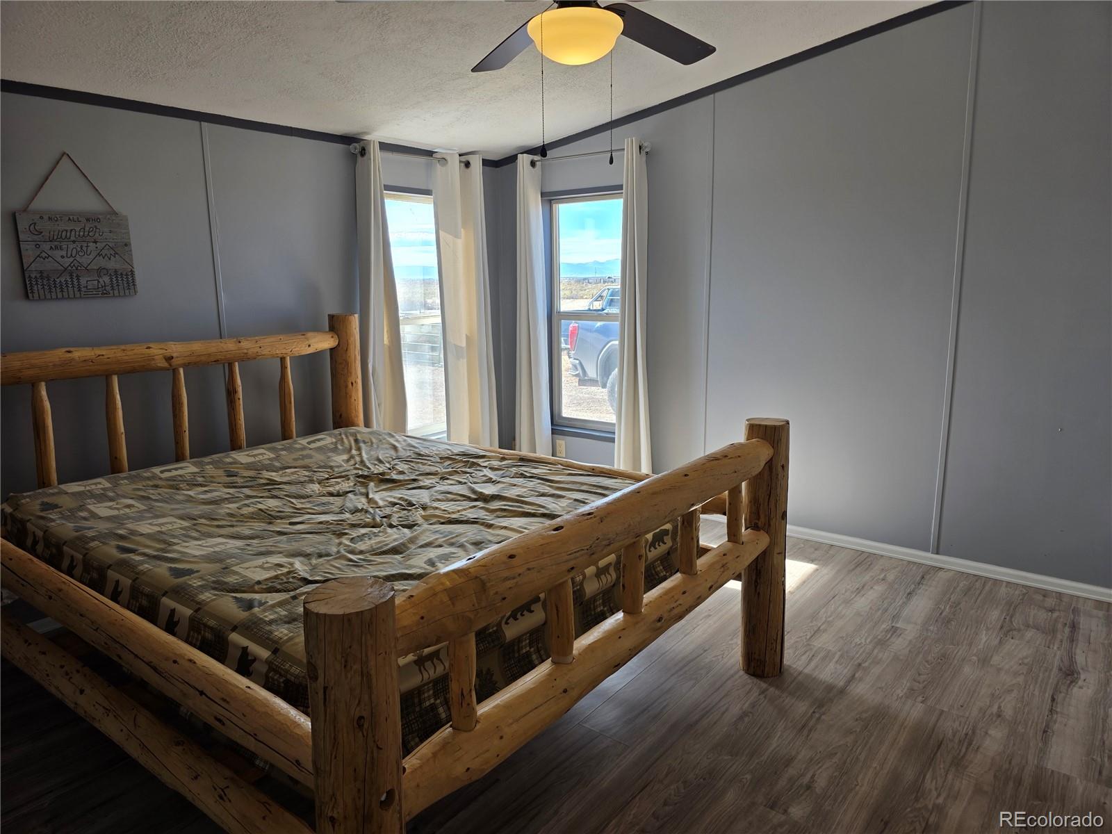 7881 Foothill Boulevard Alamosa, CO 81101 - Photo 7 of 25 a bed sitting in a bedroom next to a window