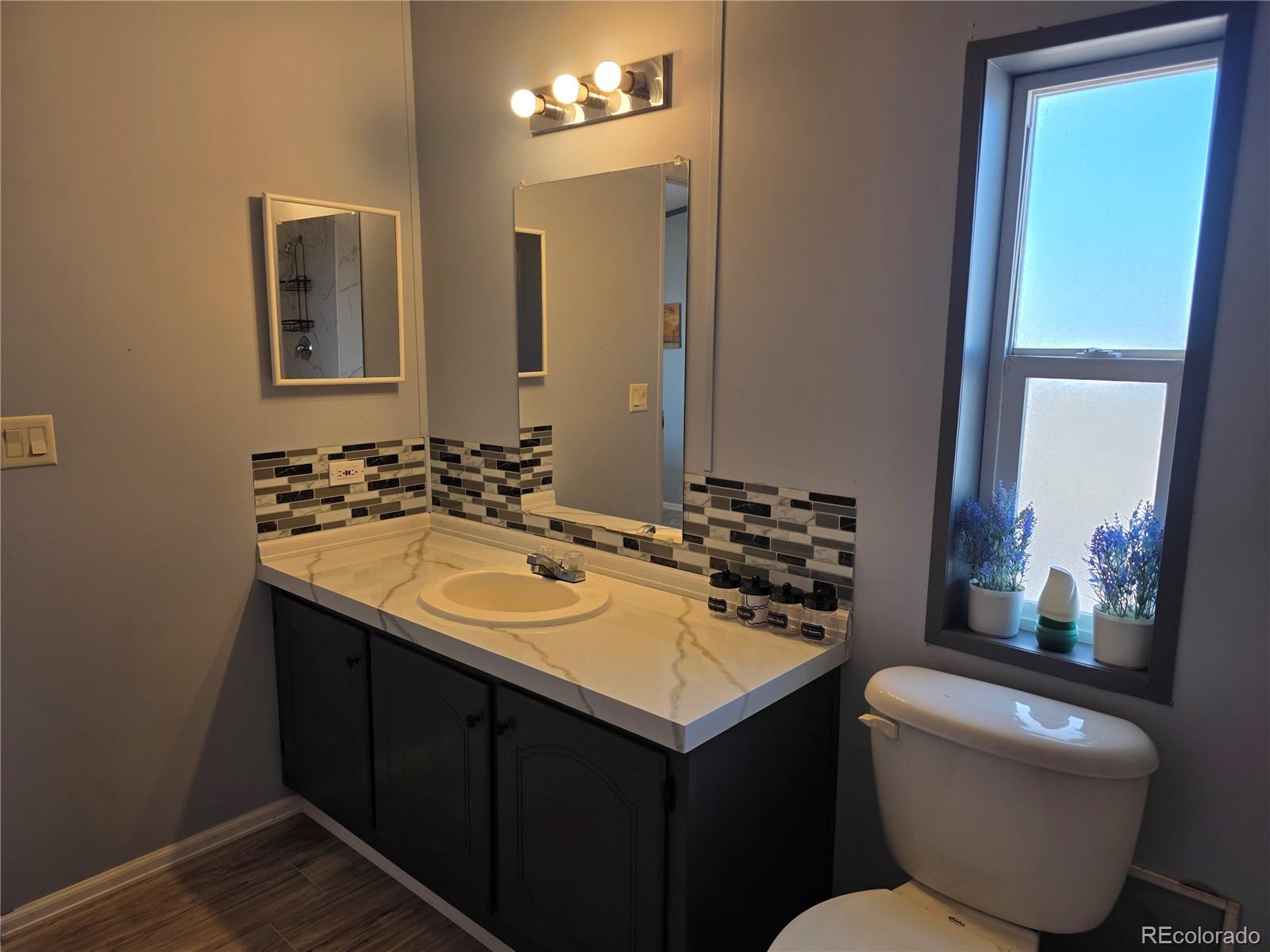 7881 Foothill Boulevard Alamosa, CO 81101 - Photo 8 of 25 a bathroom with a sink and a mirror