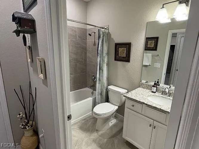 2190 Clementine Street Naples, FL 34120 - Photo 14 of 16 a bathroom with a sink a toilet and a mirror