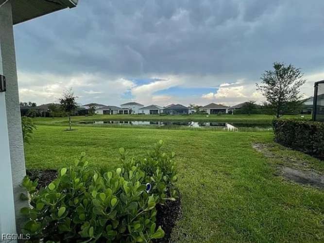 2190 Clementine Street Naples, FL 34120 - Photo 2 of 16 a view of a big yard with plants and large trees