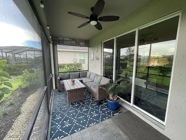 a view of a hallway with living room and furniture