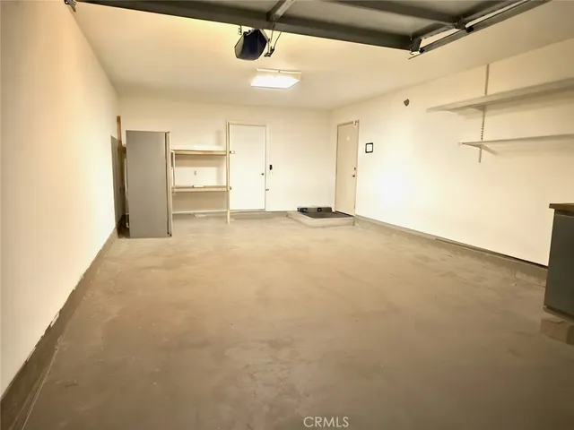 a view of a white house with many windows and yard