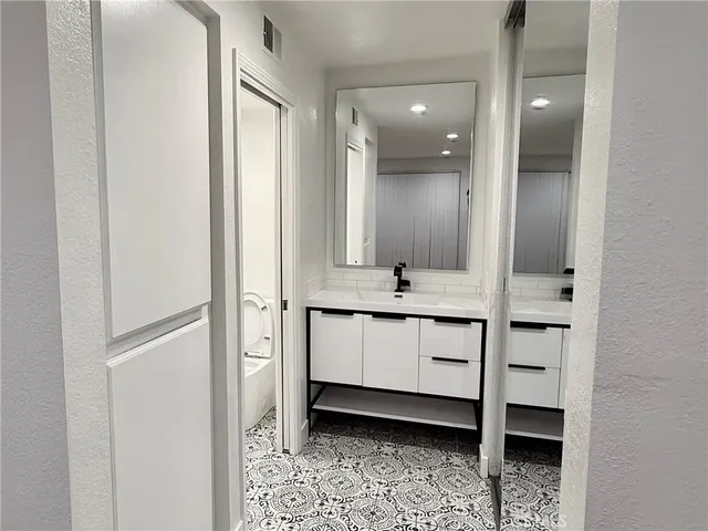 a bathroom with a double vanity sink and mirror