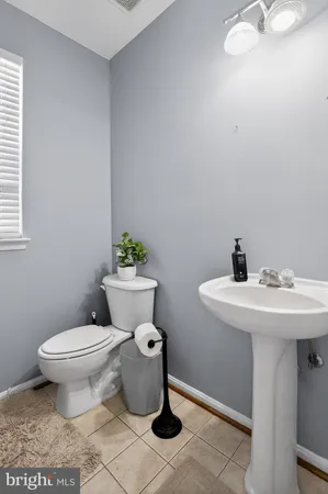 a bathroom with a sink toilet and a mirror