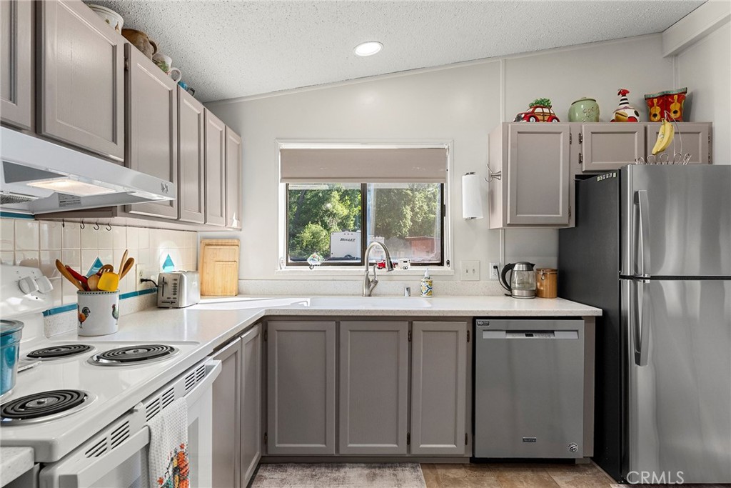 1477 Flag Creek Road Oroville, CA 95965 - Photo 26 of 75 a kitchen with a sink a refrigerator and window