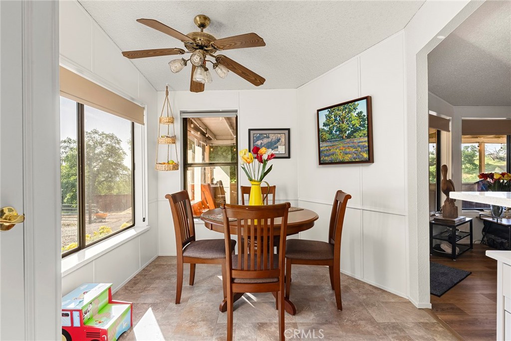 1477 Flag Creek Road Oroville, CA 95965 - Photo 27 of 75 a view of a dining room with furniture window and wooden floor
