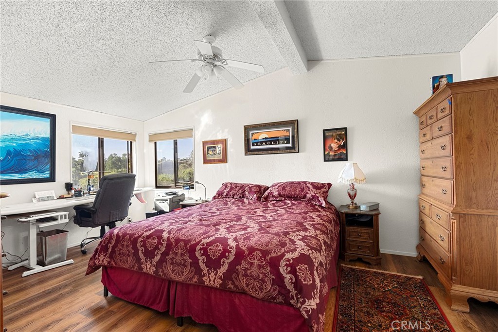 1477 Flag Creek Road Oroville, CA 95965 - Photo 28 of 75 a bedroom with a bed and wooden floor