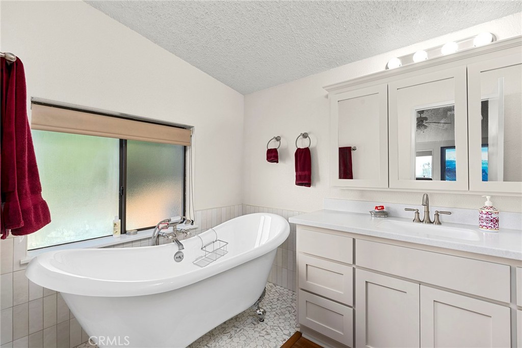 1477 Flag Creek Road Oroville, CA 95965 - Photo 29 of 75 a bathroom with a double vanity sink and mirror