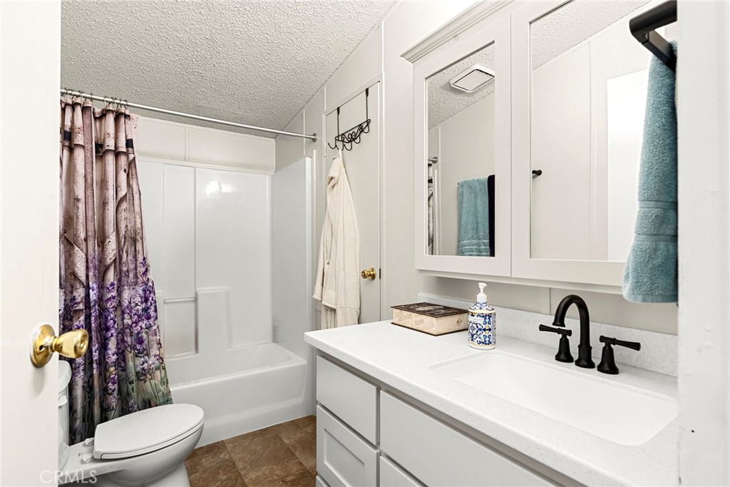 1477 Flag Creek Road Oroville, CA 95965 - Photo 30 of 75 a bathroom with a sink a toilet and a large mirror