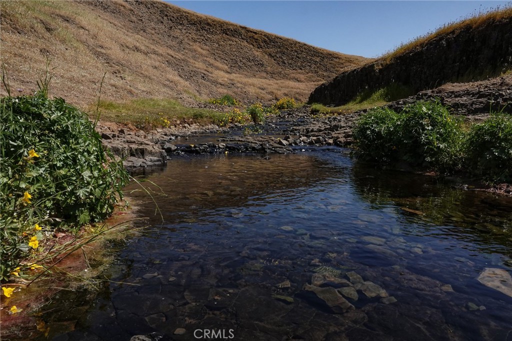 1477 Flag Creek Road Oroville, CA 95965 - Photo 75 of 75 a view of a lake with mountains in the background