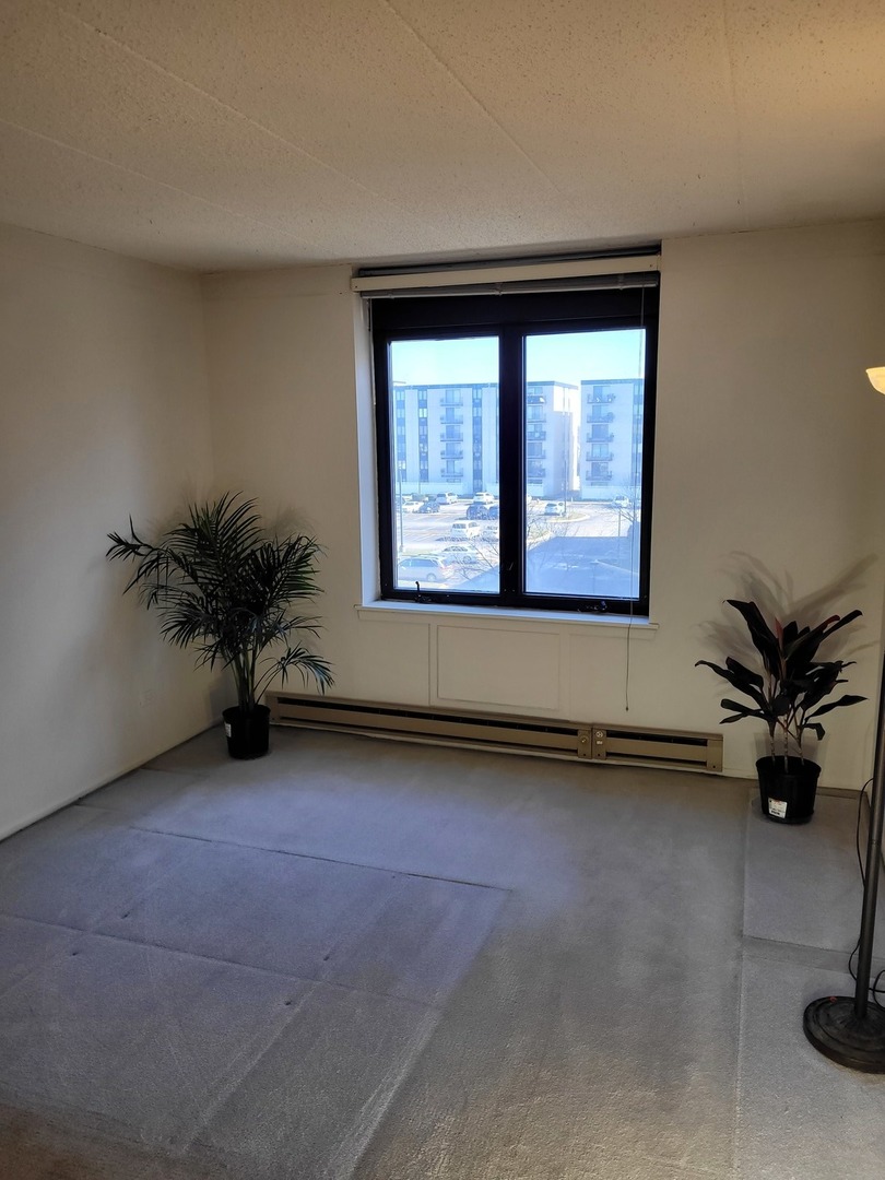 9701 Dee Road, Unit 4F Niles, IL 60714 - Photo 8 of 20 a view of a room with a window