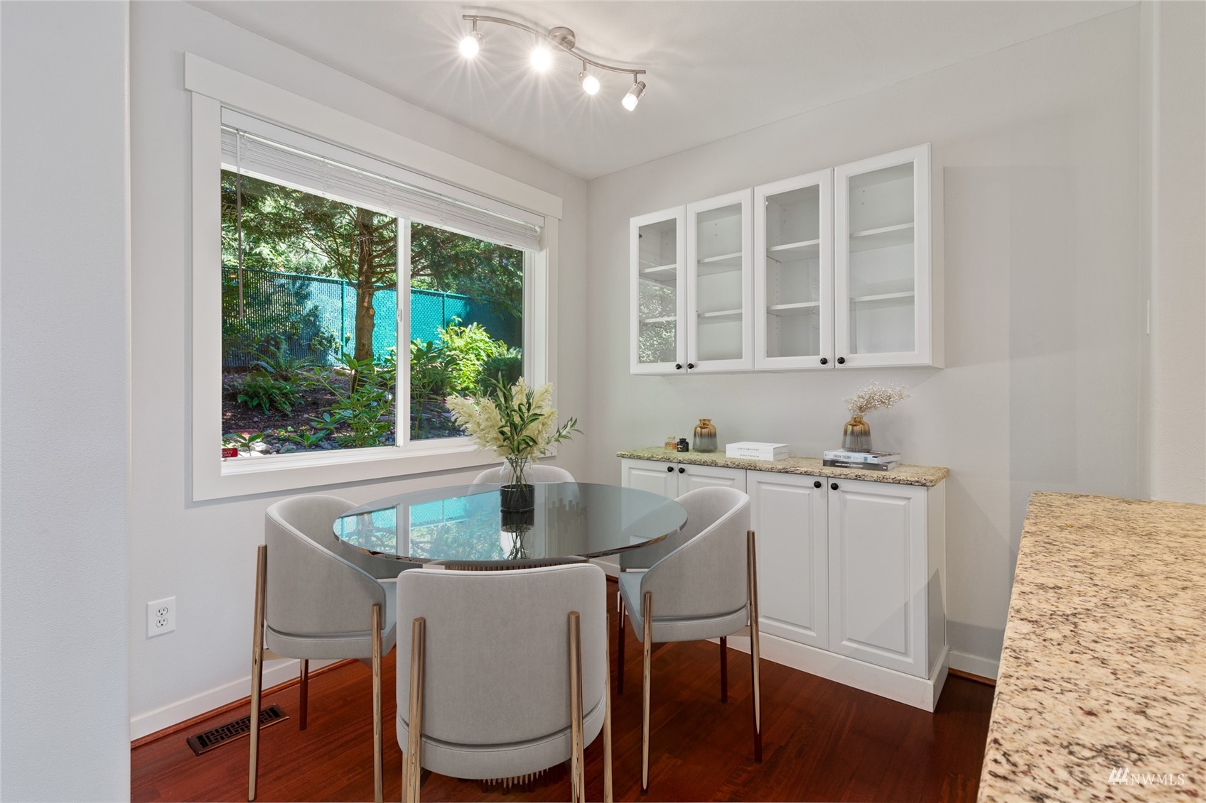23300 Southeast Black Nugget Road, Unit D3 Issaquah, WA 98029 - Photo 12 of 27 a kitchen with a table chairs sink and cabinets