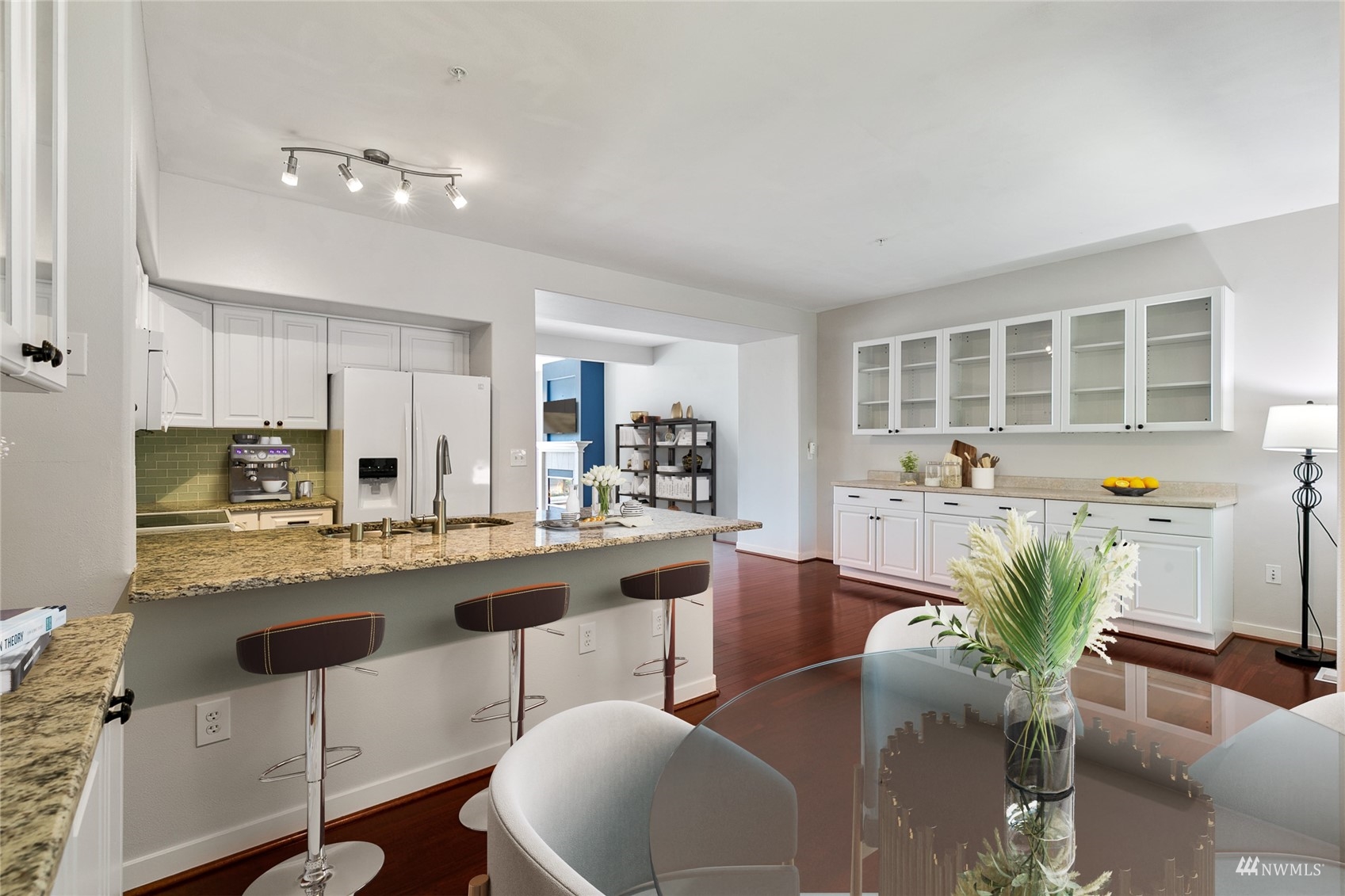 23300 Southeast Black Nugget Road, Unit D3 Issaquah, WA 98029 - Photo 13 of 27 a kitchen with stainless steel appliances granite countertop a kitchen island a stove a cabinets a dining table and chairs