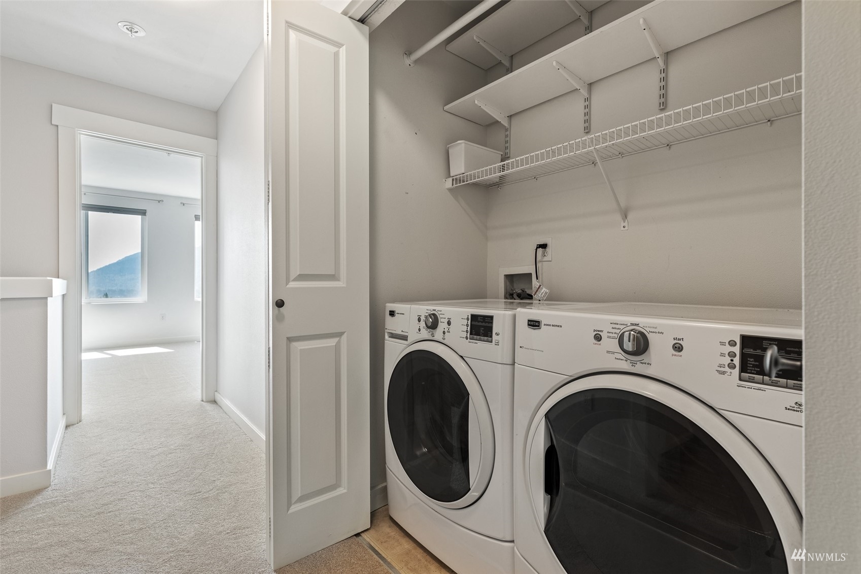 23300 Southeast Black Nugget Road, Unit D3 Issaquah, WA 98029 - Photo 20 of 27 a view of a hallway with washer and dryer
