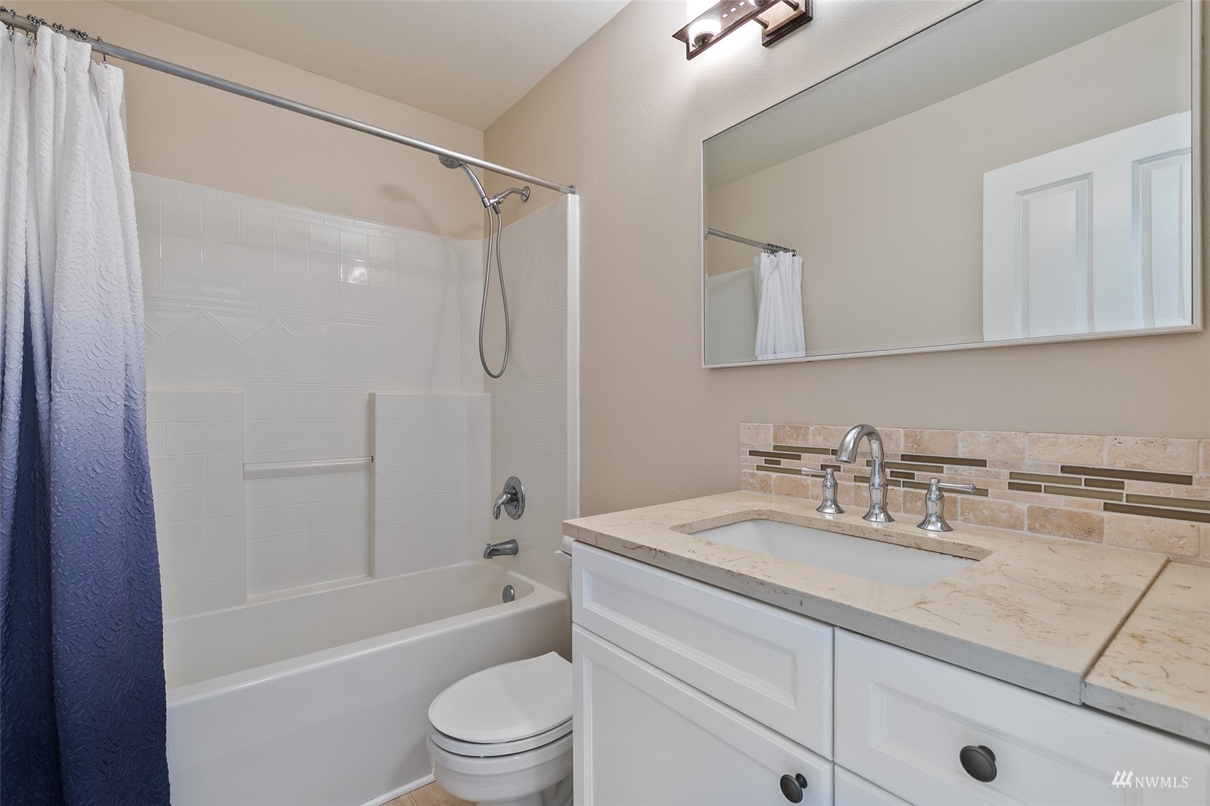 23300 Southeast Black Nugget Road, Unit D3 Issaquah, WA 98029 - Photo 22 of 27 a bathroom with a sink toilet and shower