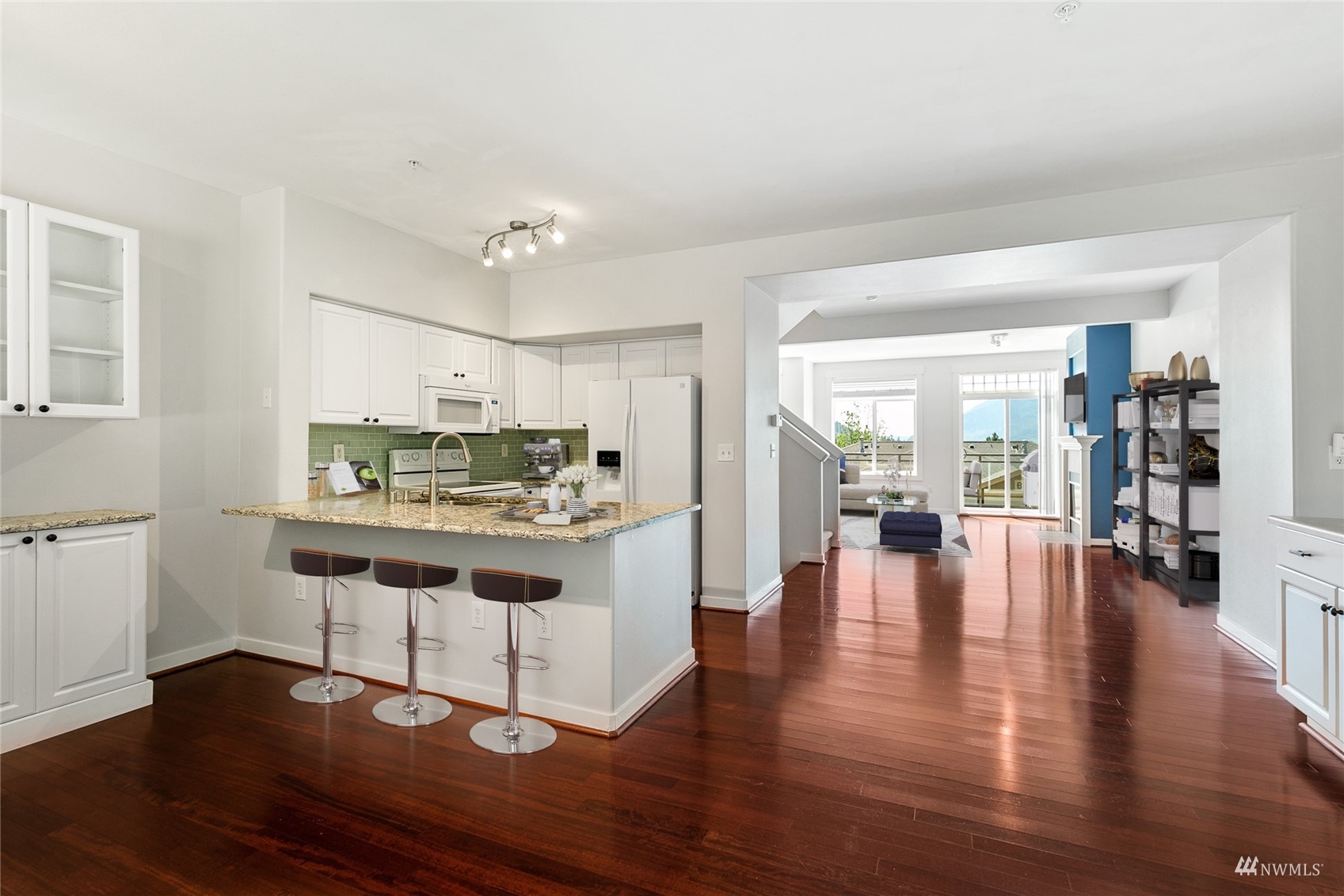 23300 Southeast Black Nugget Road, Unit D3 Issaquah, WA 98029 - Photo 6 of 27 a view of kitchen with dining table chairs and wooden floor