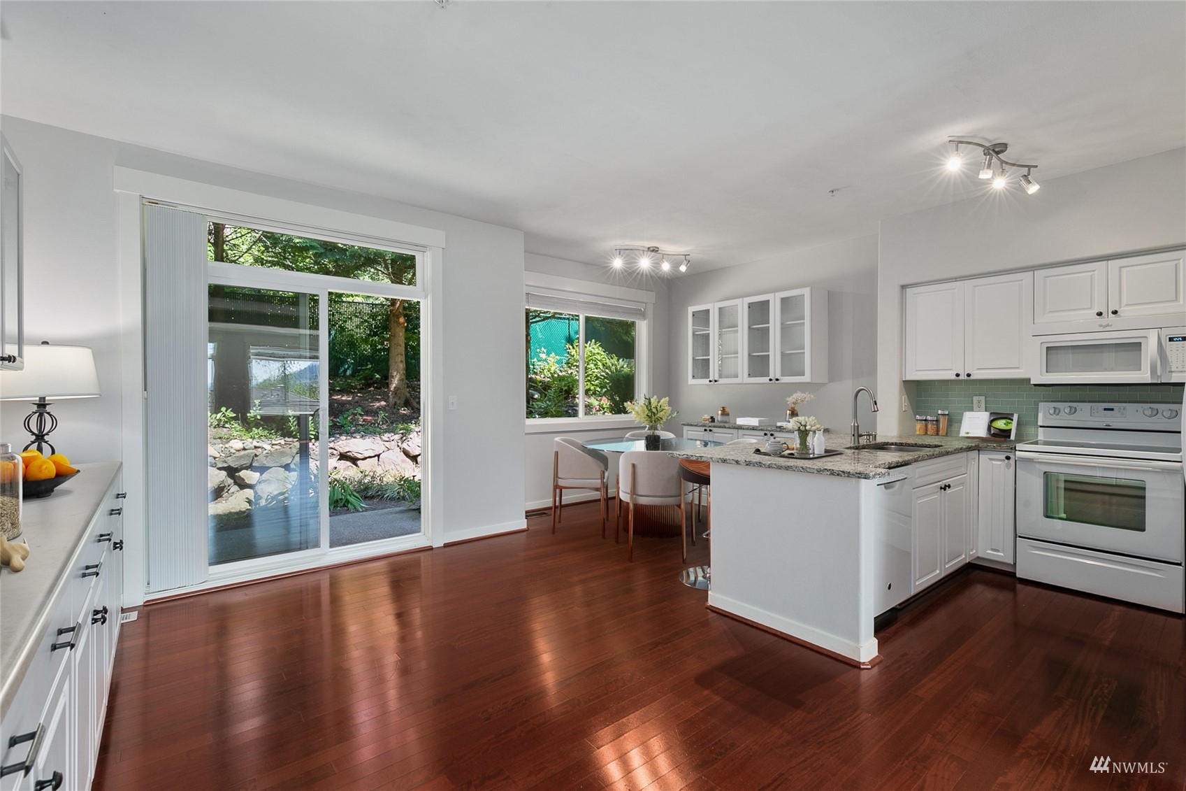 23300 Southeast Black Nugget Road, Unit D3 Issaquah, WA 98029 - Photo 7 of 27 a kitchen with sink cabinets and wooden floor