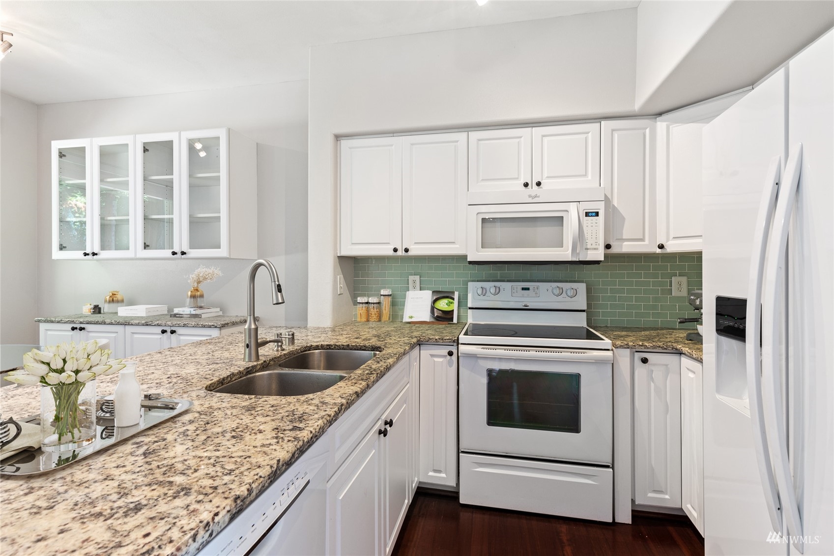 23300 Southeast Black Nugget Road, Unit D3 Issaquah, WA 98029 - Photo 9 of 27 a kitchen with granite countertop a sink a stove and cabinets