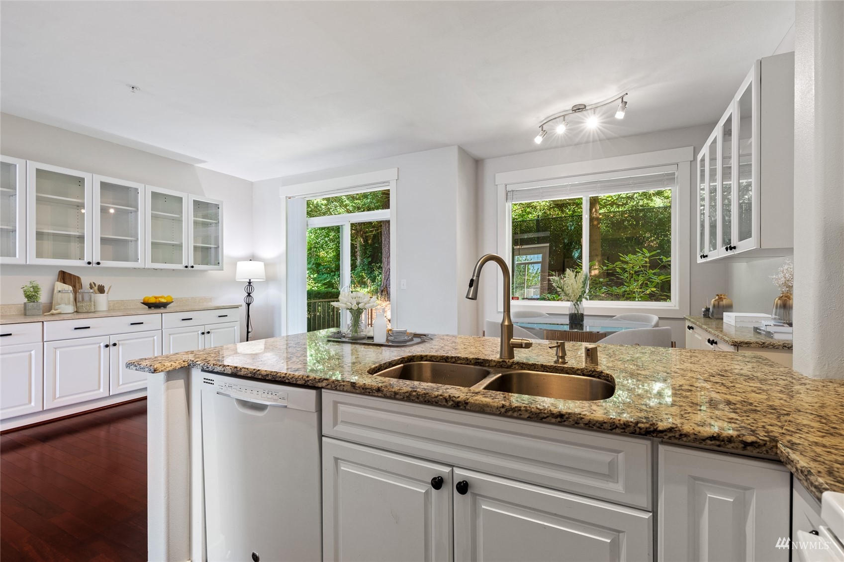 23300 Southeast Black Nugget Road, Unit D3 Issaquah, WA 98029 - Photo 10 of 27 a kitchen with granite countertop a sink and white cabinets