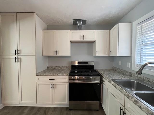 6935 Fielder Road Rex, GA 30273 - Photo 8 of 22 a kitchen with granite countertop white cabinets and white appliances