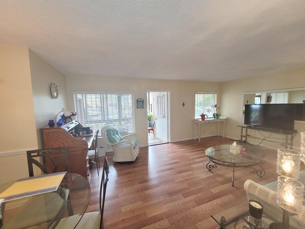 320 Pine Ridge Circle, Unit A1 Greenacres, FL 33463 - Photo 8 of 65 a living room with furniture and wooden floor