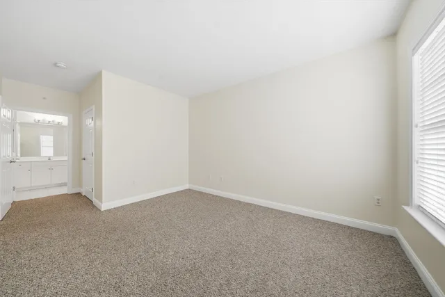 an empty room with a empty space and windows