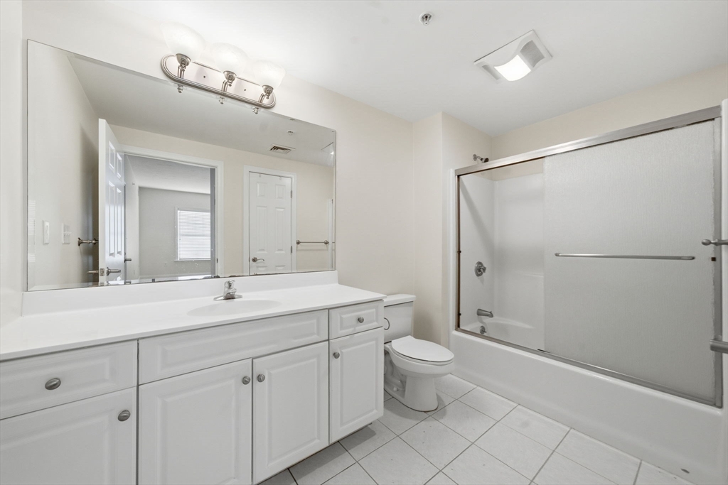295 Salem Street, Unit 82 Woburn, MA 01801 - Photo 16 of 36 a spacious bathroom with a double vanity sink a mirror and a toilet