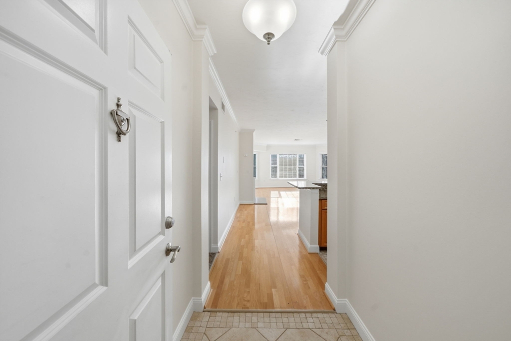 295 Salem Street, Unit 82 Woburn, MA 01801 - Photo 23 of 36 a view of a hallway with wooden floor and staircase