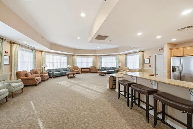 a living room with furniture a table and a large window