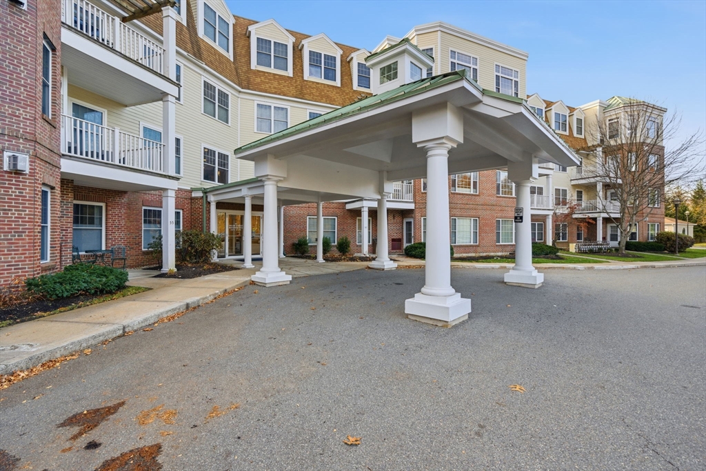295 Salem Street, Unit 82 Woburn, MA 01801 - Photo 33 of 36 a front view of a building with a road
