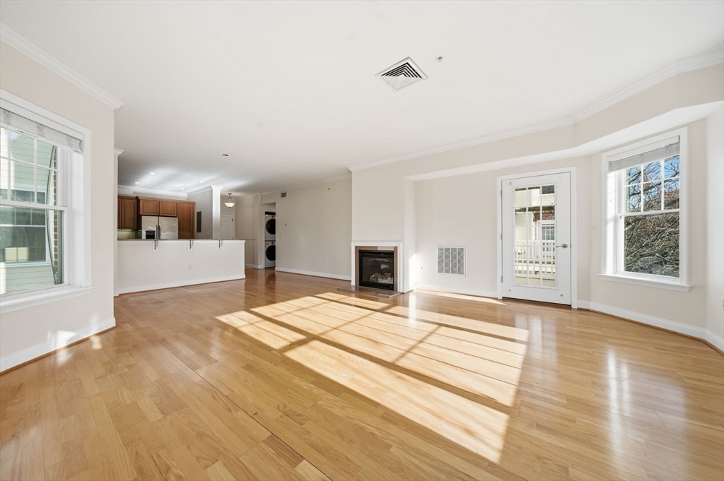 295 Salem Street, Unit 82 Woburn, MA 01801 - Photo 4 of 36 a view of an empty room with window and wooden floor