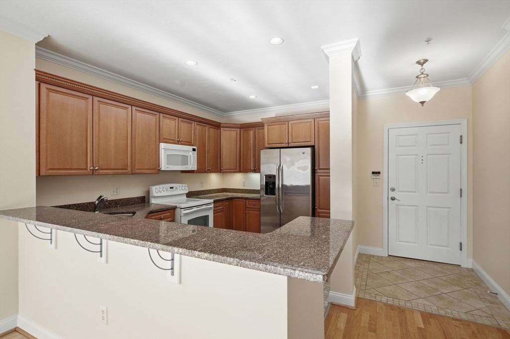 295 Salem Street, Unit 82 Woburn, MA 01801 - Photo 10 of 36 a kitchen with granite countertop a sink a stove and refrigerator
