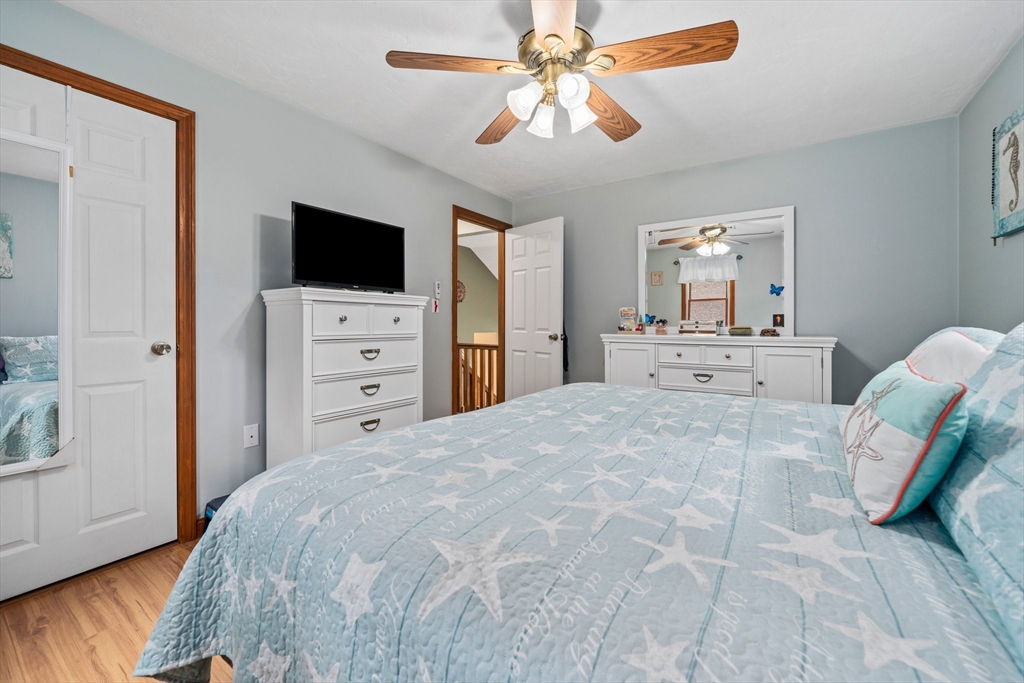 7 Signal Hill Road Marshfield, MA 02050 - Photo 15 of 42 a spacious bedroom with a bed and a chandelier